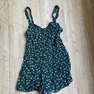 Urban outfitters, small, dark green romper. White flowers all over and buttons.